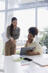 Two business woman working together for analysis data plan business strategies in office, Business discussing and startup concept.