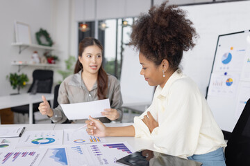 Two business woman working together for analysis data plan business strategies in office, Business discussing and startup concept.