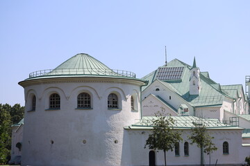 A large white building with a green roof, ideal for architecture or urban planning images