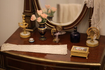A dresser with a mirror, vases, and a mirror on top