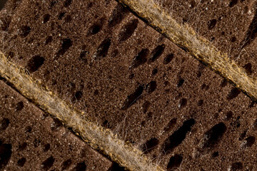 porous sponge with lots of holes for good foaming of detergents and is used for cleaning, close up