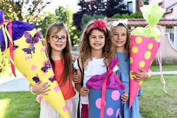 Happy little children with sweets in a cone on the first day of school. Back to school