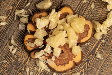 sweet sliced yellow citrus, delicious fresh citrus on a wooden board, close up