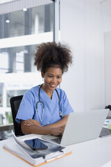 Smiling Female Doctor with Clipboard and Laptop for Online Medical Consultation working in Modern...
