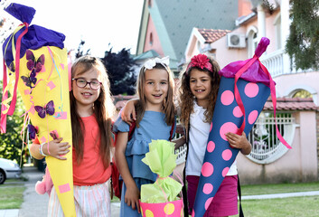 Happy little children with sweets in a cone on the first day of school. Back to school