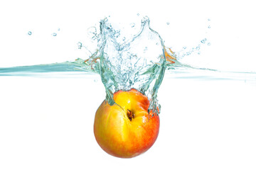 Dynamic Splash Of A Juicy Nectarine Into Clear Water