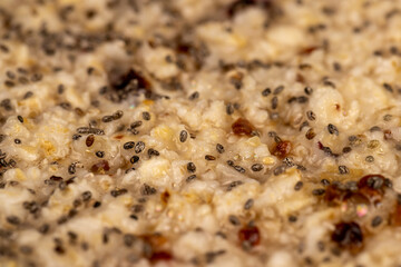 oatmeal porridge with dried berries in a black bowl , cooking instant oatmeal porridge, chia in...