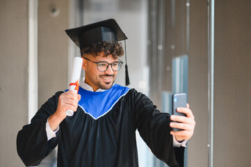 Happy arab student making a video call after graduation ceremony