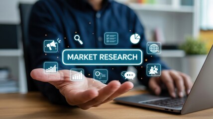 Strategic Market Research: A person interacting with a laptop displaying a "MARKET RESEARCH" interface, illustrating data analysis, consumer insights, and competitive intelligence for business growth