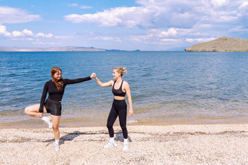 Two women engaged in cardio training on a beautiful beach during a sunny day