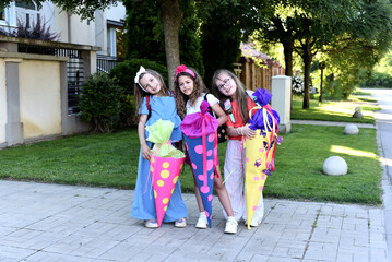 Happy little children with sweets in a cone on the first day of school. Back to school
