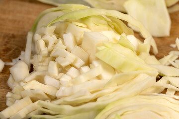 fresh cabbage chopped into small pieces for convenience of cooking, close up, white cabbage after washing during cooking
