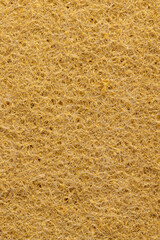 rigid fabric for washing large dirt on objects, glued and tightly intertwined synthetic sand-colored threads on a sponge that is used for cleaning and washing