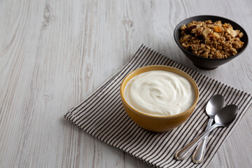 Organic Whole Fat Greek Yogurt in a Bowl, side view. Copy space.