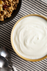 Organic Whole Fat Greek Yogurt in a Bowl, top view. Flat lay, overhead.