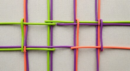 A colorful woven pattern showcasing green, purple, and orange rubber bands creating a playful and
