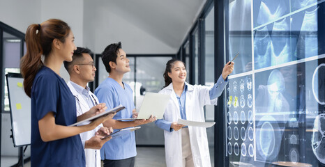 Medical team shows and explains MRI having a meeting in conference room at hospital, Medical technology and health care concept.