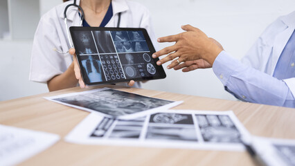 Medical team shows and explains MRI having a meeting in conference room at hospital, Medical technology and health care concept.