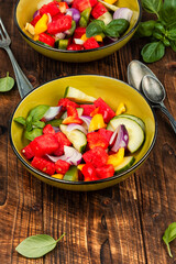 Bowl of salad with watermelon, cucumber.