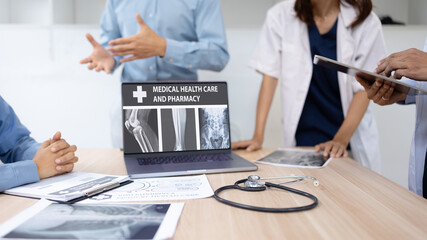Medical team with laptop computer and examine x ray test results for treatment plans in a modern hospital, Healthcare and medical concept.