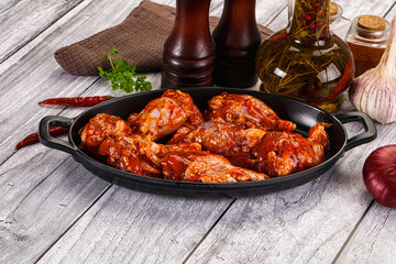 Raw marinated buffalo chicken wings