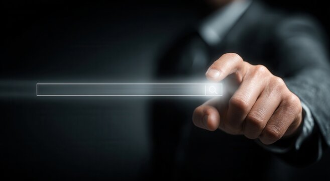 Businessman's hand pointing at a search bar with a glass, transparent virtual interface for web searching technology and online research against a black background. Detailed.