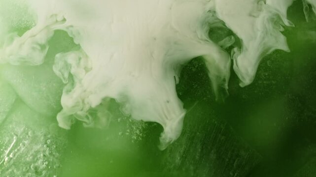 Super Slow Motion Detail Shot of Pouring Cream into Matcha Latte at 1000fps.