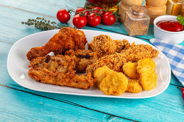 Golden crispy fried chicken mix - wings, drumsticks, nuggets and strips
