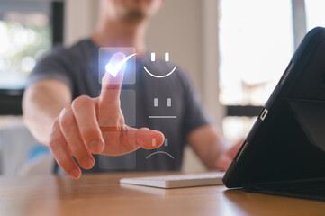 Fototapeta premium Customer service satisfaction survey concept.Businessman or customers show satisfaction by pressing tick correct mark on face emoticon smile in satisfaction on virtual touch screen
