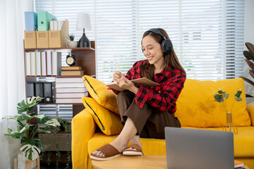 Cozy Study Session: A young person immerses themselves in a book, headphones perched comfortably on...