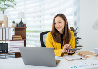 Professional at Work: A focused professional, dressed in a stylish blazer, meticulously reviews...