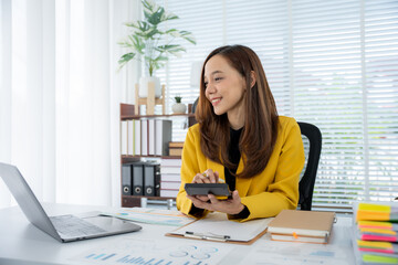 Efficient Office Day: A professional woman is immersed in her work, calculating numbers with a...
