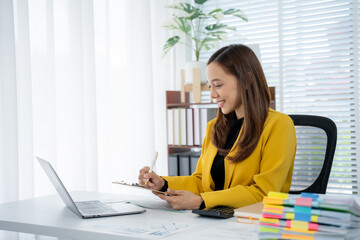 Focused Professional at Desk: A diligent professional, engrossed in her work, is captured amidst an...