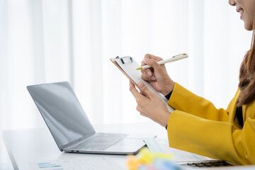 Focus on Planning and Assessment: A focused individual meticulously takes notes on a clipboard,...