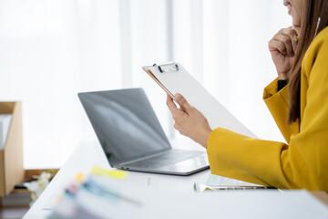 Focused Business Woman: A businesswoman in yellow jacket, engrossed in a thoughtful contemplation,...