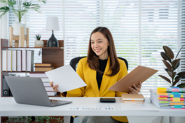 Office Efficiency: A professional, dressed in a yellow jacket, focuses intently on paperwork within...