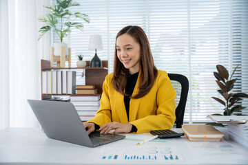 Focused Professional: A confident businesswoman engages in a task at her desk, bathed in the...
