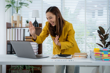 Virtual Connection: A woman is joyfully engaged in a video call, radiating warmth and openness....