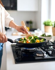 Woman cooking vegetables on stove