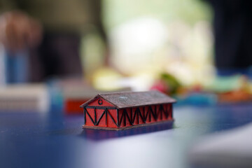 A model of a small red house on a table