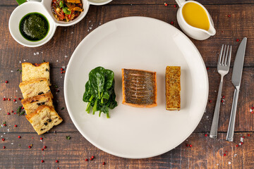 Seared salmon fillet served with wilted spinach and potato croquette