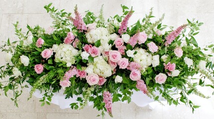 Vibrant floral arrangement captured from above on a clean white surface.