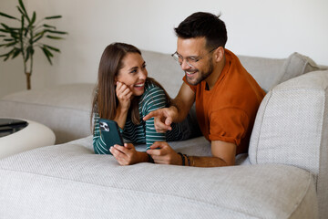 A couple in love is trying out a new app on their phone