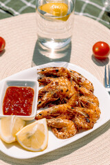 Garlic butter shrimp with lemon juice, grilled to perfection and paired with tangy tomato-based dipping sauce, a flavorful and healthy seafood meal