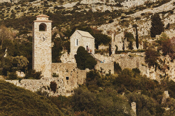 Stylized vintage view of Venetian and Osman citadel ruins with clock tower in Old Bar, Montenegro