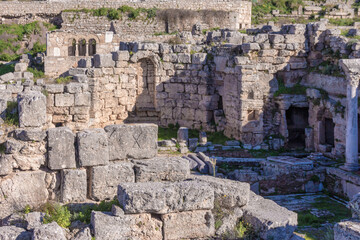 Ruined stone buildings and ancient structures in the archaeological site of Corinth, Greece