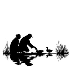 Silhouette of people feeding ducks by a pond, seen against a white backdrop. Silhouette shows man and woman feeding ducks, reflected in still water with reeds in the background.