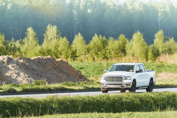 Modern truck driving on a rural sunny road