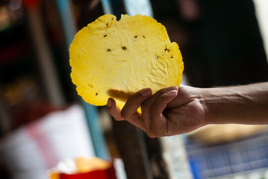 A man holds dry pasta made from flour in the market