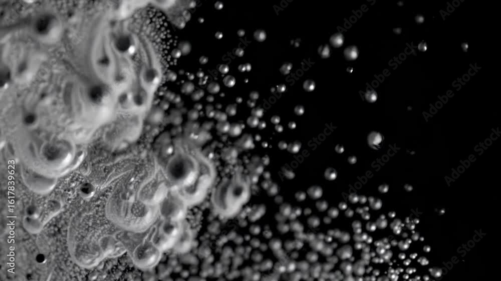 Poster the video captures a mesmerizing close-up of water droplets in motion, creating an abstract, dynamic
